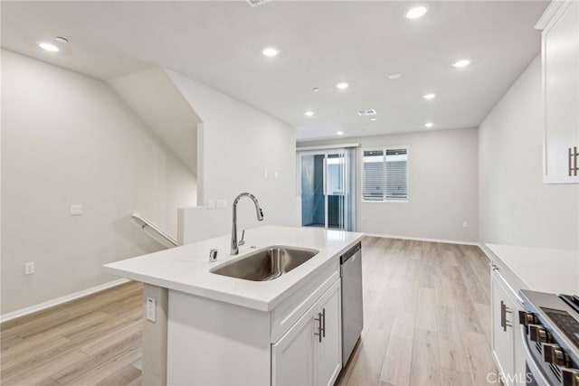 2720 Crozier Ct, Pomona, CA 91767 - kitchen with a sink, appliances with stainless steel finishes, light wood-style floors, light countertops, and a center island with sink