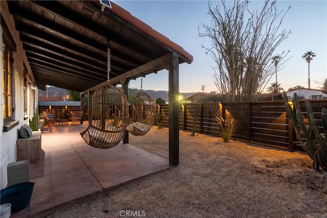 view of patio terrace at dusk