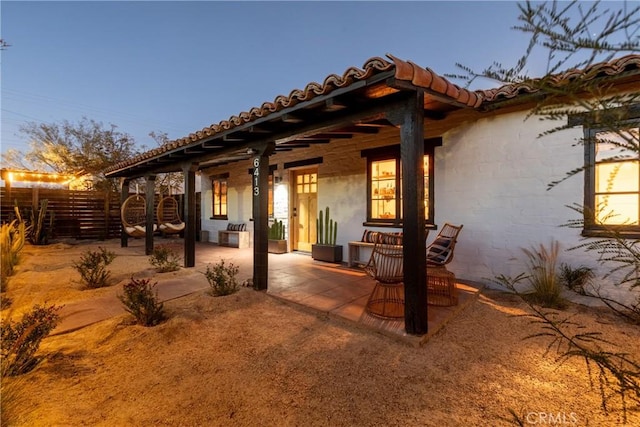 view of patio terrace at dusk