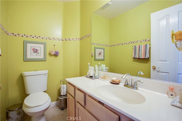 bathroom with vanity, tile patterned floors, and toilet