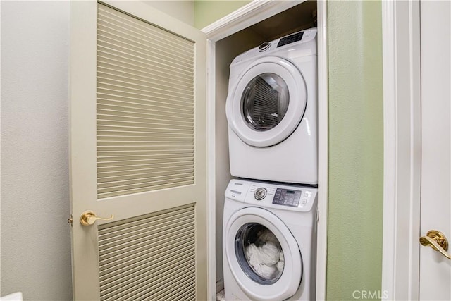 laundry area with stacked washer and dryer