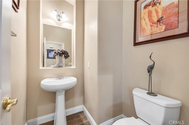 bathroom featuring sink, toilet, and hardwood / wood-style floors