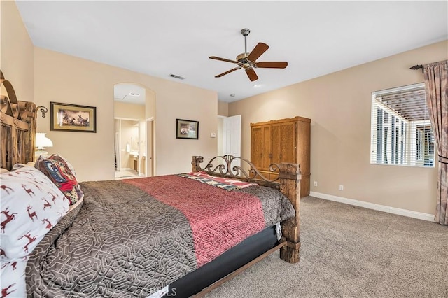 bedroom with carpet, connected bathroom, and ceiling fan