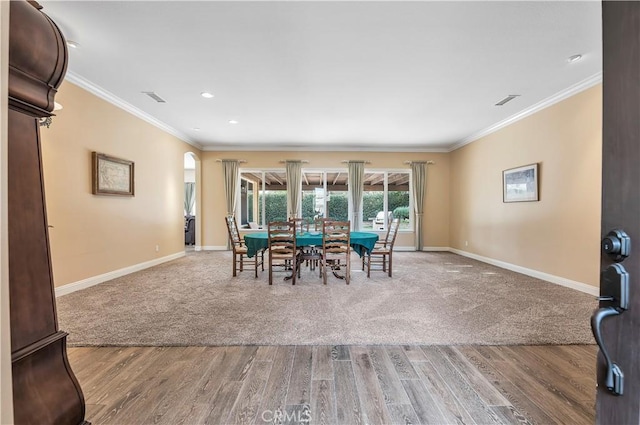 dining room with ornamental molding and hardwood / wood-style floors