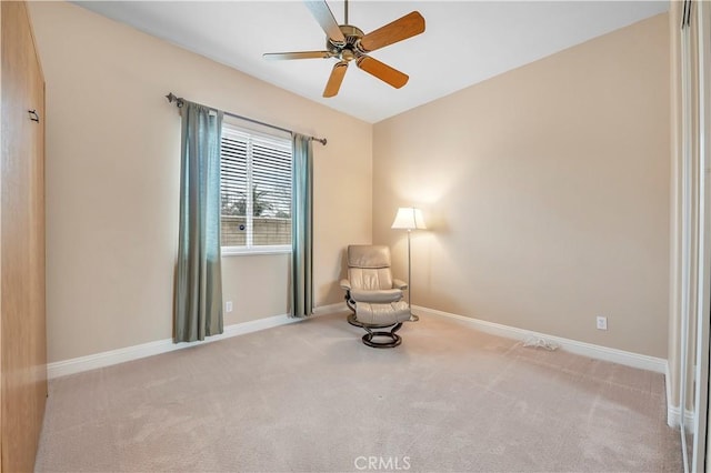 sitting room with light colored carpet and ceiling fan