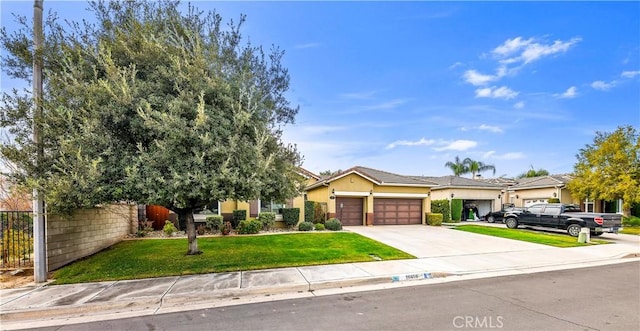 view of front of home featuring a garage and a front lawn