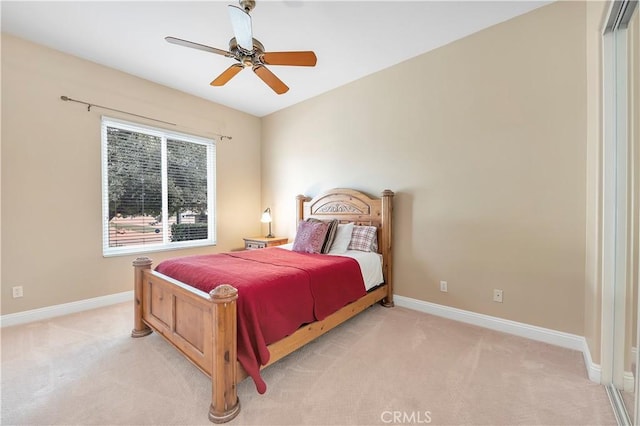 bedroom with light carpet and ceiling fan