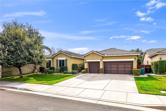 ranch-style home featuring a garage and a front lawn