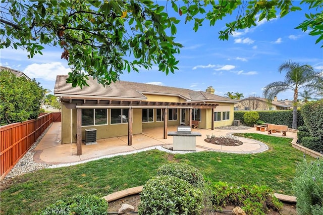 back of property with cooling unit, a lawn, and a patio