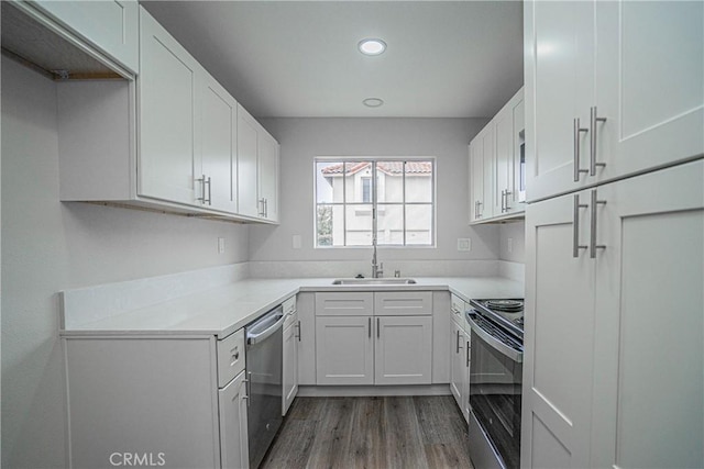 kitchen with white cabinetry, stainless steel appliances, and sink