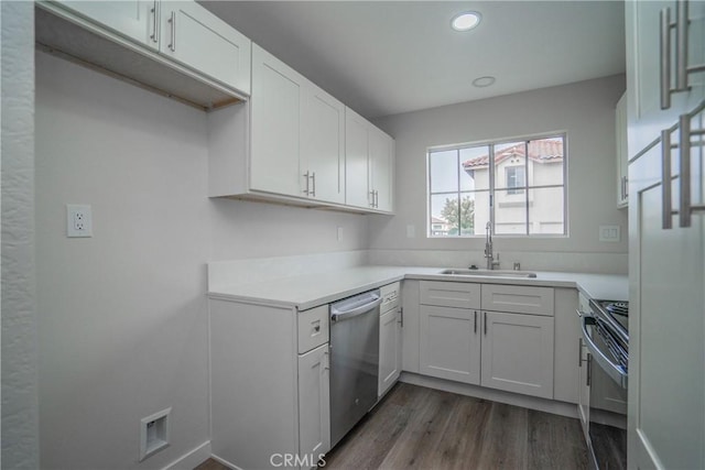 kitchen featuring stainless steel appliances, dark hardwood / wood-style flooring, sink, and white cabinets