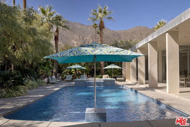 view of pool featuring a mountain view and a patio area