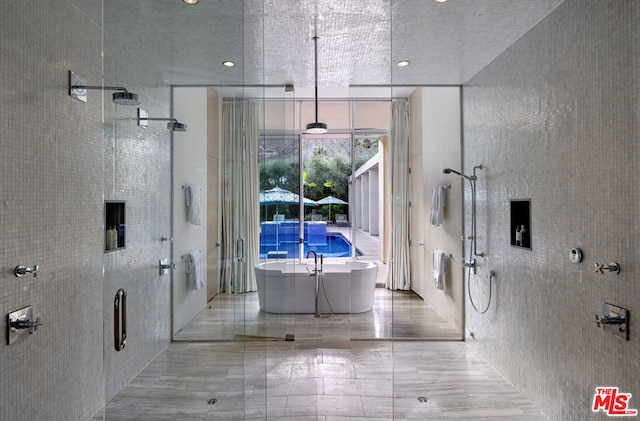 bathroom with independent shower and bath and tile walls