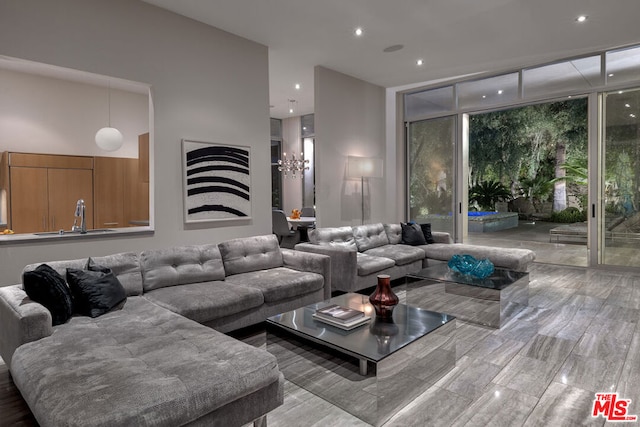 living room featuring a towering ceiling and expansive windows