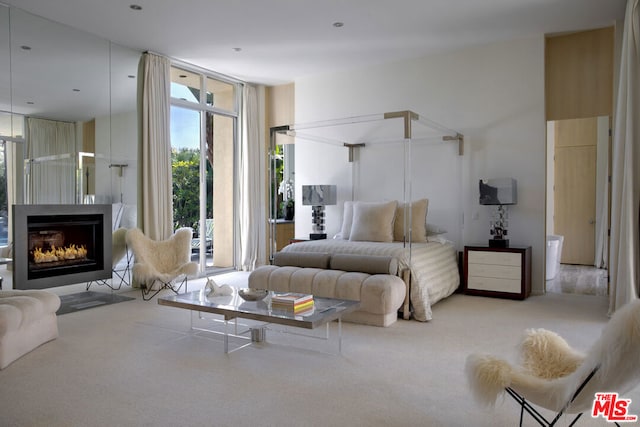 bedroom featuring access to exterior and a wall of windows