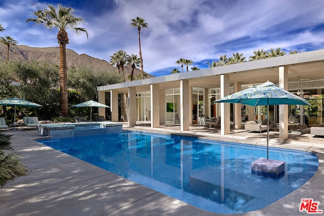 view of swimming pool featuring a mountain view and a patio area