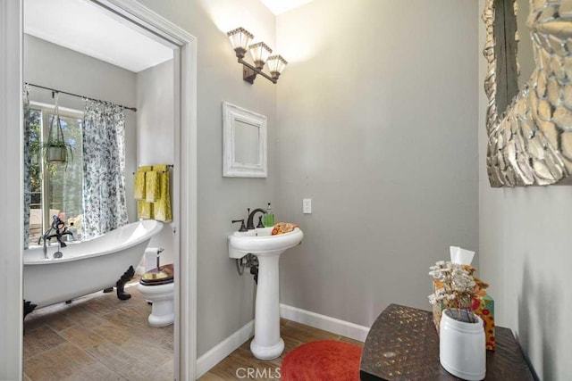 bathroom with toilet and a bathing tub