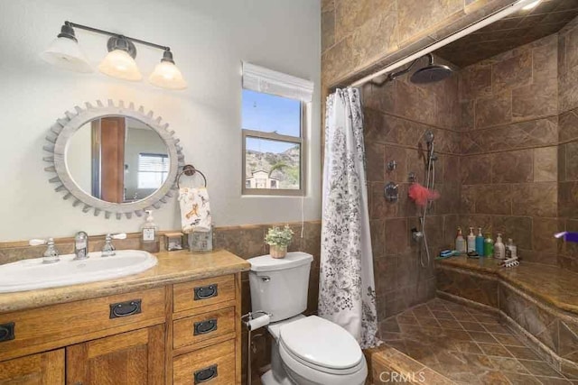 bathroom featuring vanity, toilet, curtained shower, and tile walls