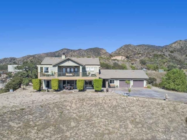 view of front of house featuring a balcony and a mountain view