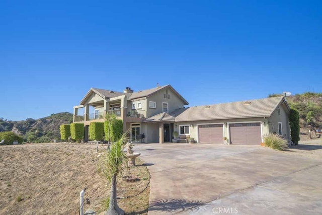 view of front property with a garage and a balcony