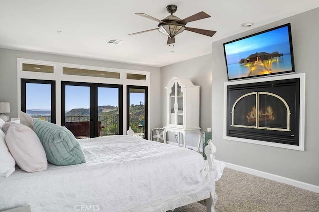 carpeted bedroom with ceiling fan and french doors