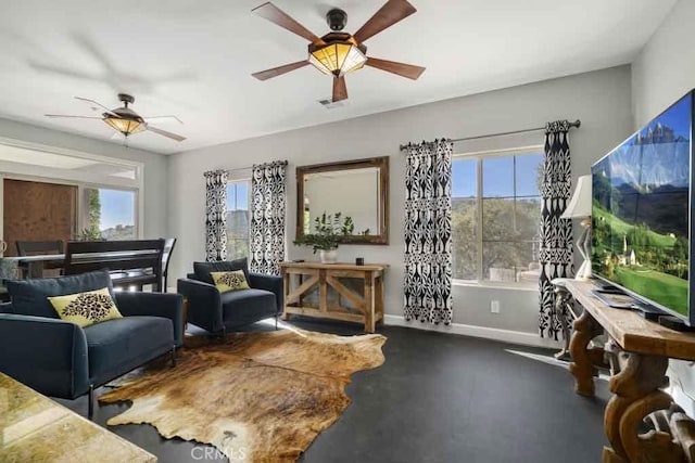 living room with plenty of natural light and ceiling fan