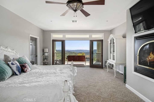 bedroom with carpet flooring, access to outside, and ceiling fan