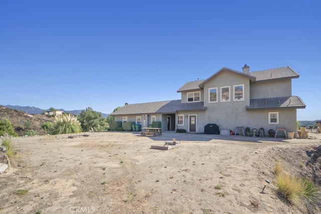 back of house with a patio area