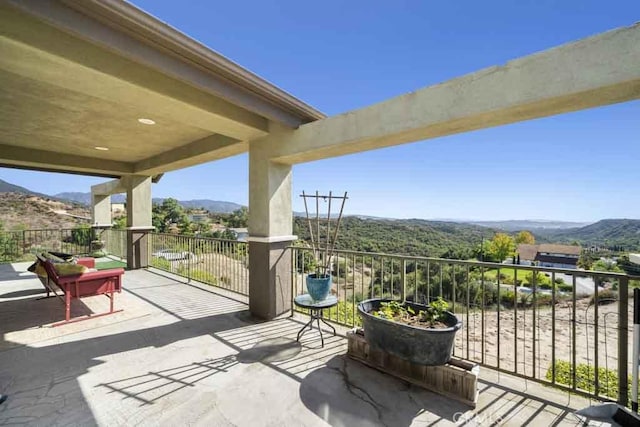 view of patio / terrace featuring a balcony and a mountain view