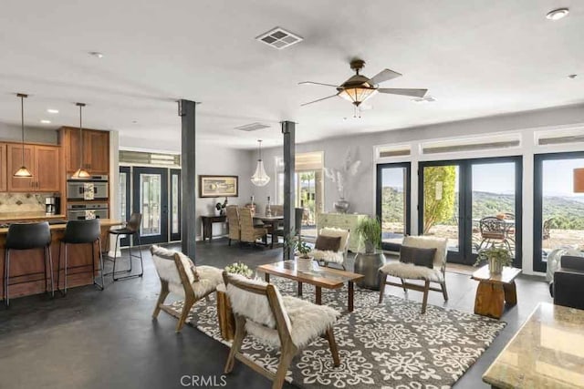 living room featuring french doors and ceiling fan