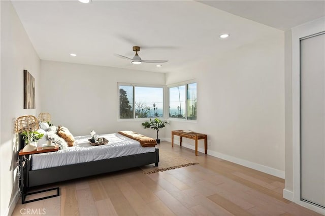 bedroom with light hardwood / wood-style flooring and ceiling fan