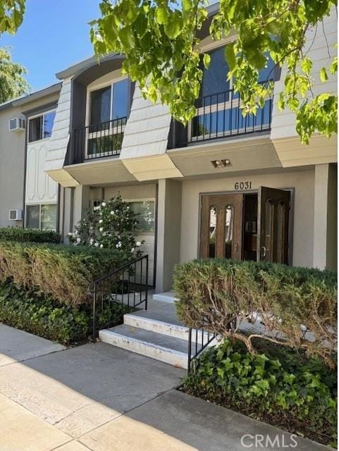 property entrance with stucco siding