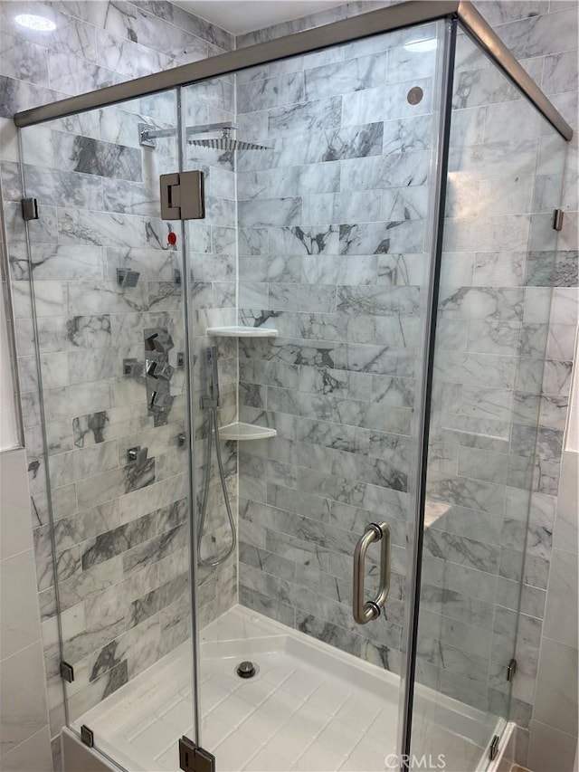 bathroom with a shower with door