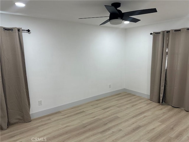 empty room featuring ceiling fan and light hardwood / wood-style floors