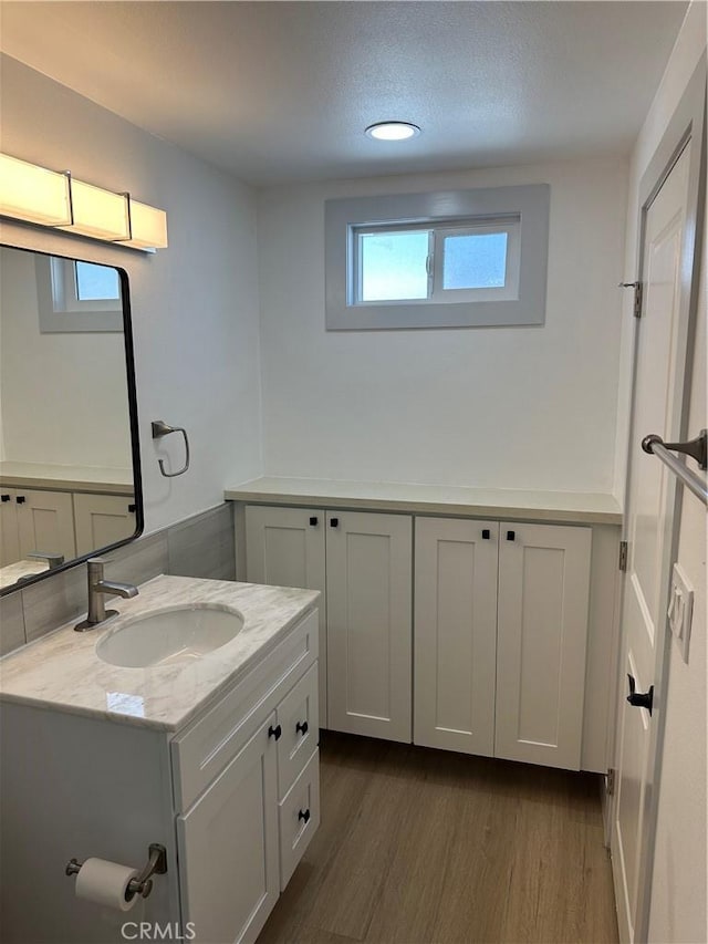 bathroom featuring wood-type flooring, a wealth of natural light, and vanity