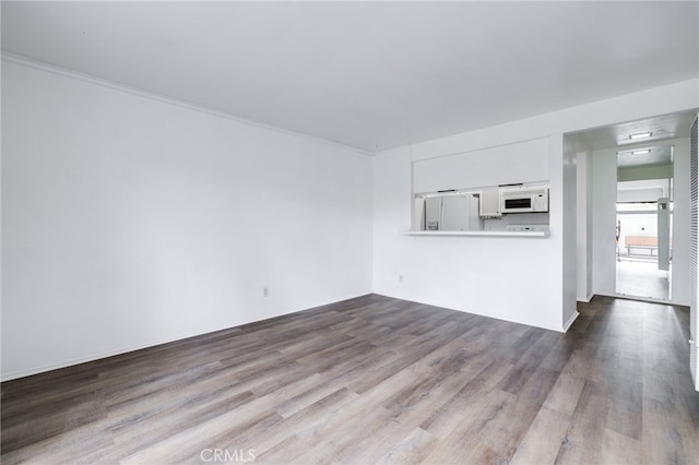 unfurnished living room with dark wood finished floors