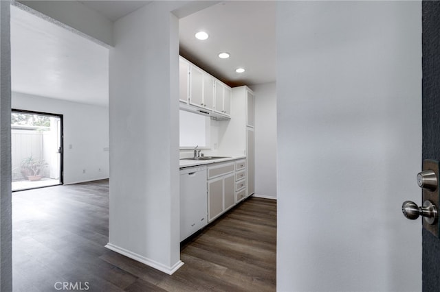 kitchen with baseboards, dishwasher, light countertops, dark wood-style floors, and white cabinets