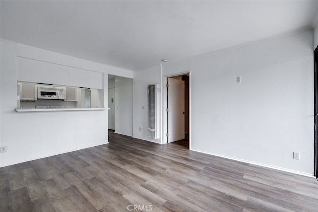 unfurnished living room featuring wood finished floors