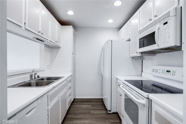 kitchen featuring white appliances, a sink, light countertops, dark wood-type flooring, and white cabinetry