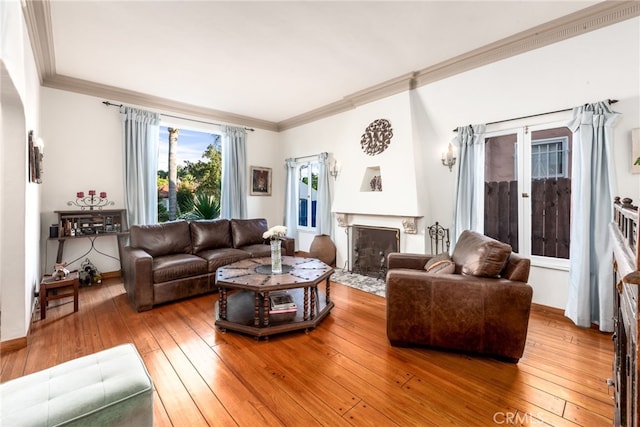 living room featuring hardwood / wood-style floors, crown molding, and french doors