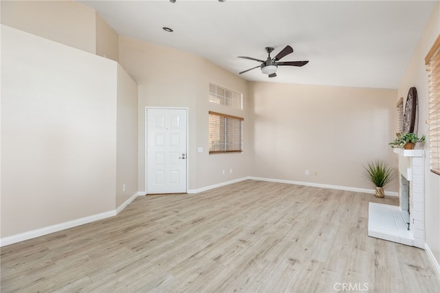 573 La Costa Dr, Banning, CA 92220 - unfurnished living room with a brick fireplace, light wood finished floors, baseboards, and ceiling fan