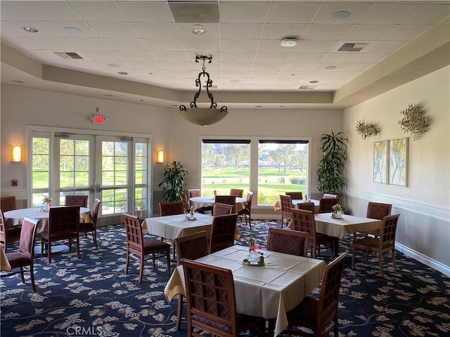 573 La Costa Dr, Banning, CA 92220 - dining area with carpet floors, a healthy amount of sunlight, french doors, and visible vents