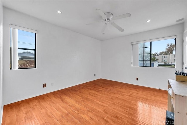 unfurnished room featuring baseboards, recessed lighting, ceiling fan, and light wood-style flooring