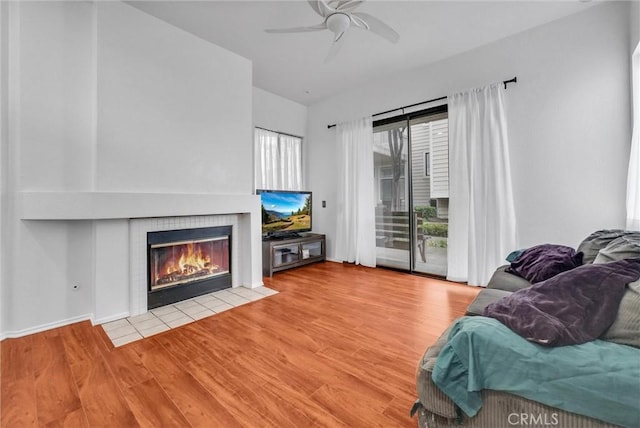 4900 N Grand Ave Unit 325, Covina, CA 91724 - living room featuring a fireplace, ceiling fan, and wood finished floors