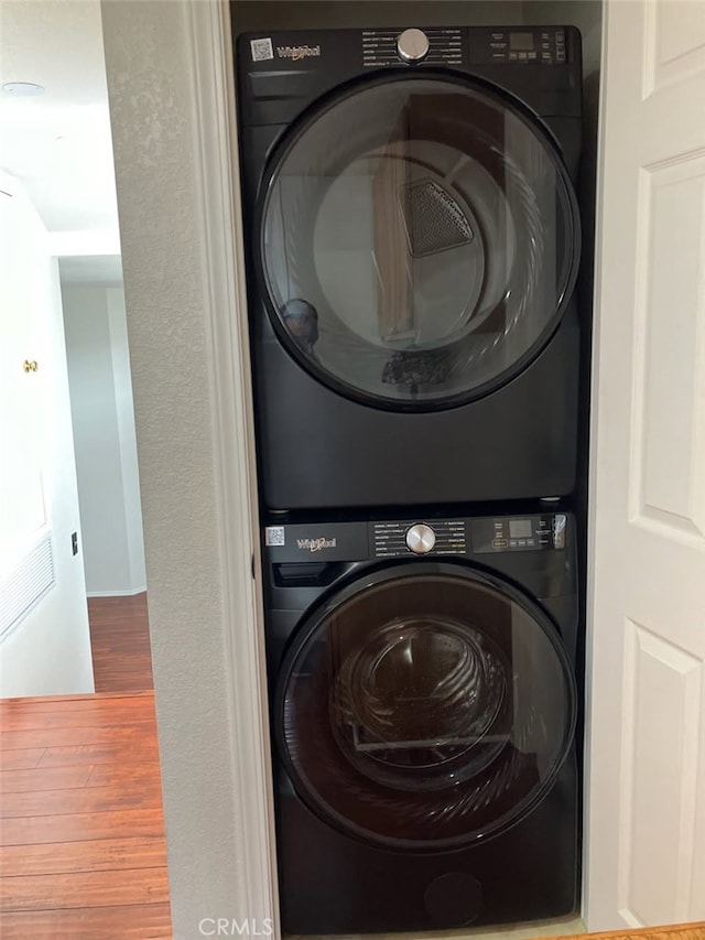 4900 N Grand Ave Unit 325, Covina, CA 91724 - laundry area featuring stacked washer / drying machine and wood finished floors