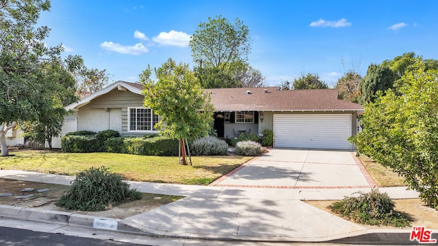 single story home with a garage and a front yard