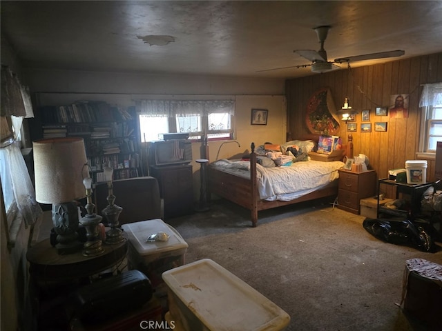 carpeted bedroom with wood walls