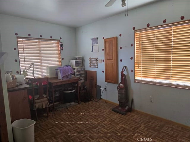 unfurnished office featuring baseboards and ceiling fan