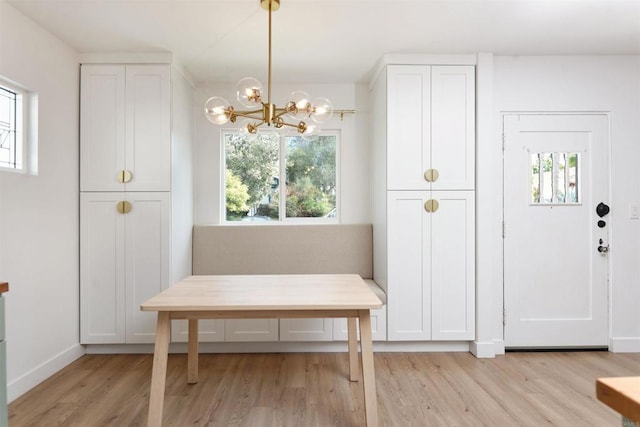 interior space with light hardwood / wood-style flooring, a notable chandelier, and plenty of natural light