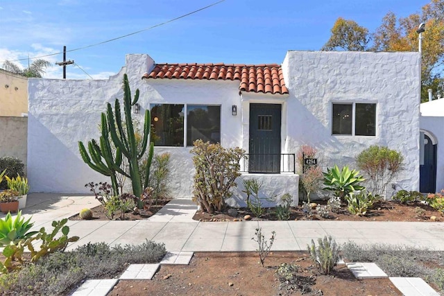 view of front of property with a tile roof and stucco siding